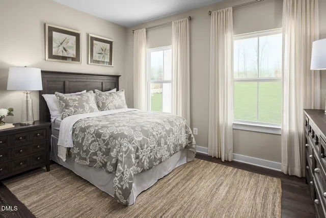 a bed sitting in a bedroom next to a window and a bedroom