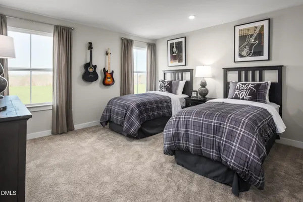 a bedroom with two beds and a window