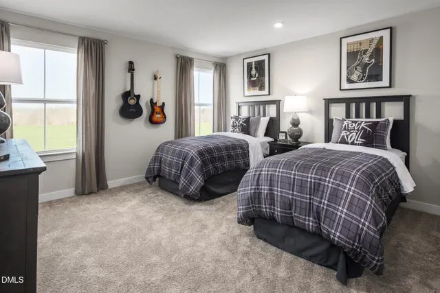 a bedroom with two beds and a window