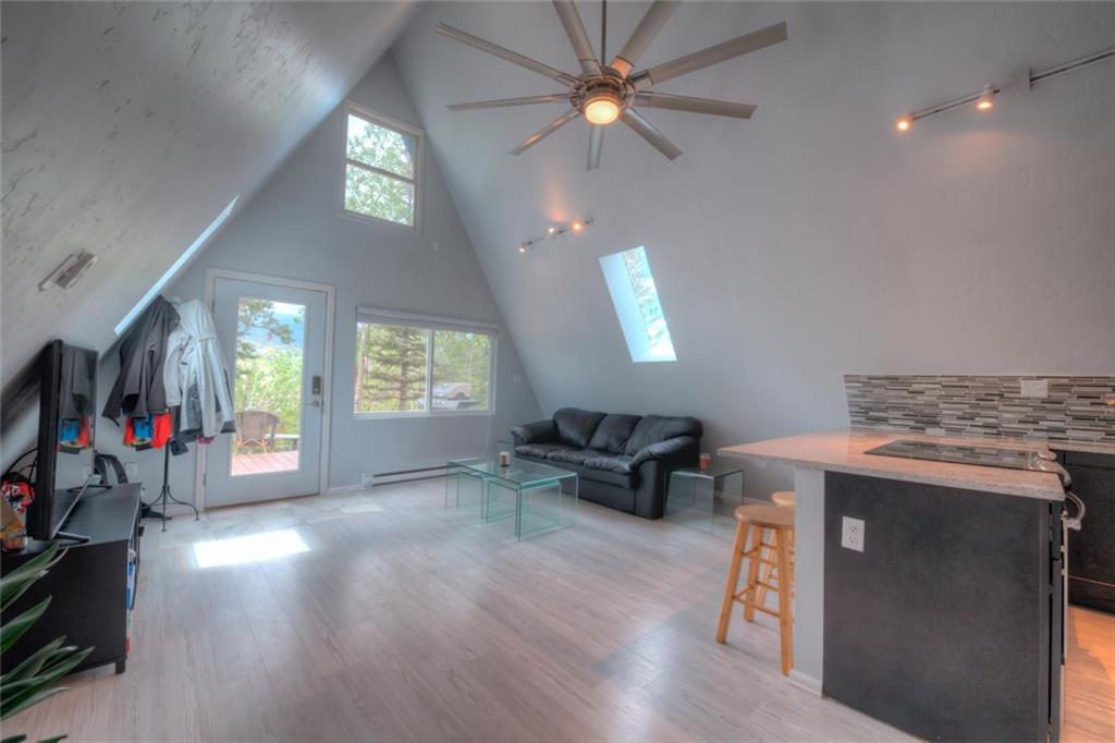 217 G Road Silverthorne, CO 80498 - Photo 3 of 24 an empty room with windows and ceiling fan