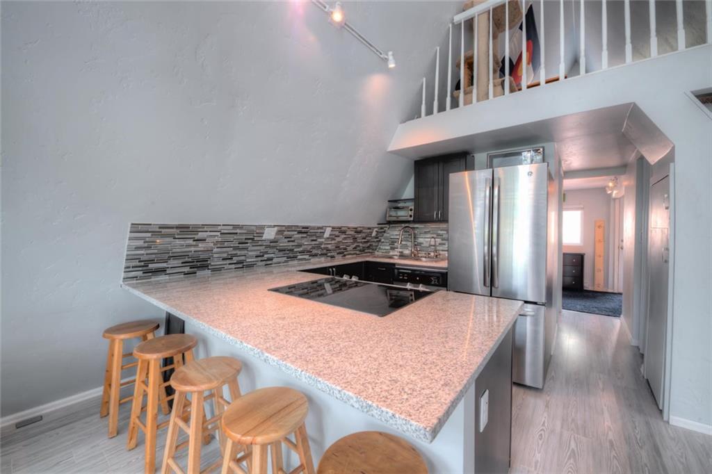 217 G Road Silverthorne, CO 80498 - Photo 4 of 24 a kitchen with stainless steel appliances granite countertop a sink and a refrigerator