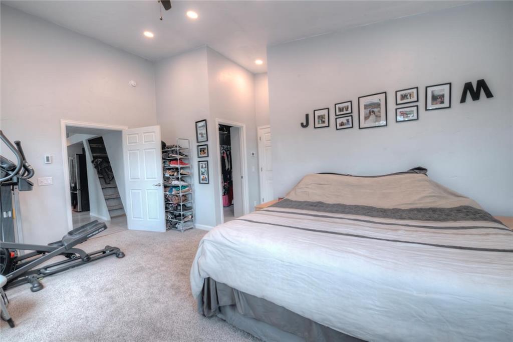 217 G Road Silverthorne, CO 80498 - Photo 9 of 24 a spacious bedroom with a bed and a flat screen tv