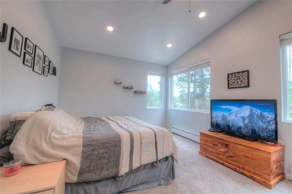 217 G Road Silverthorne, CO 80498 - Photo 10 of 24 a spacious bedroom with a bed and glass window