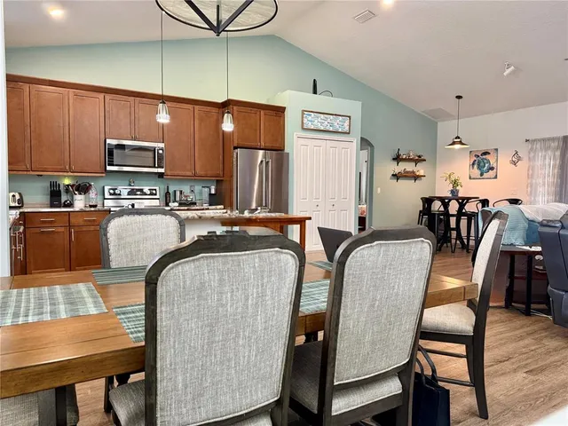 a dining room with furniture and a kitchen view