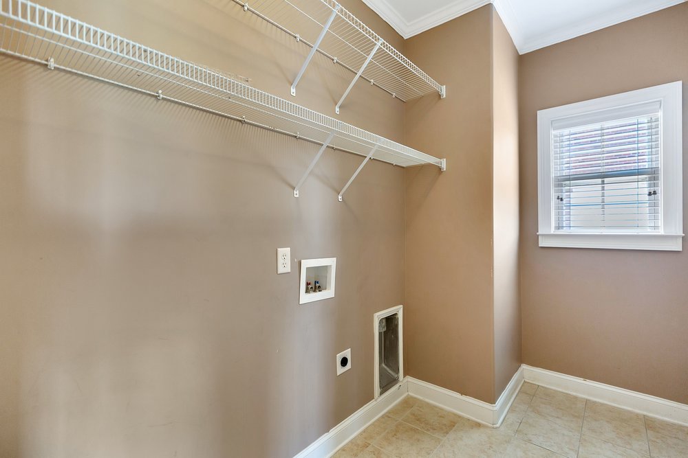 15 Fawn Hill Drive Anderson, SC 29621 - Photo 17 of 38 This functional laundry room features convenient shelving and a window for natural light.