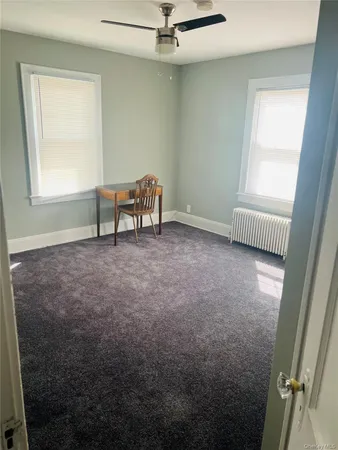 a bedroom with a bed and a mirror