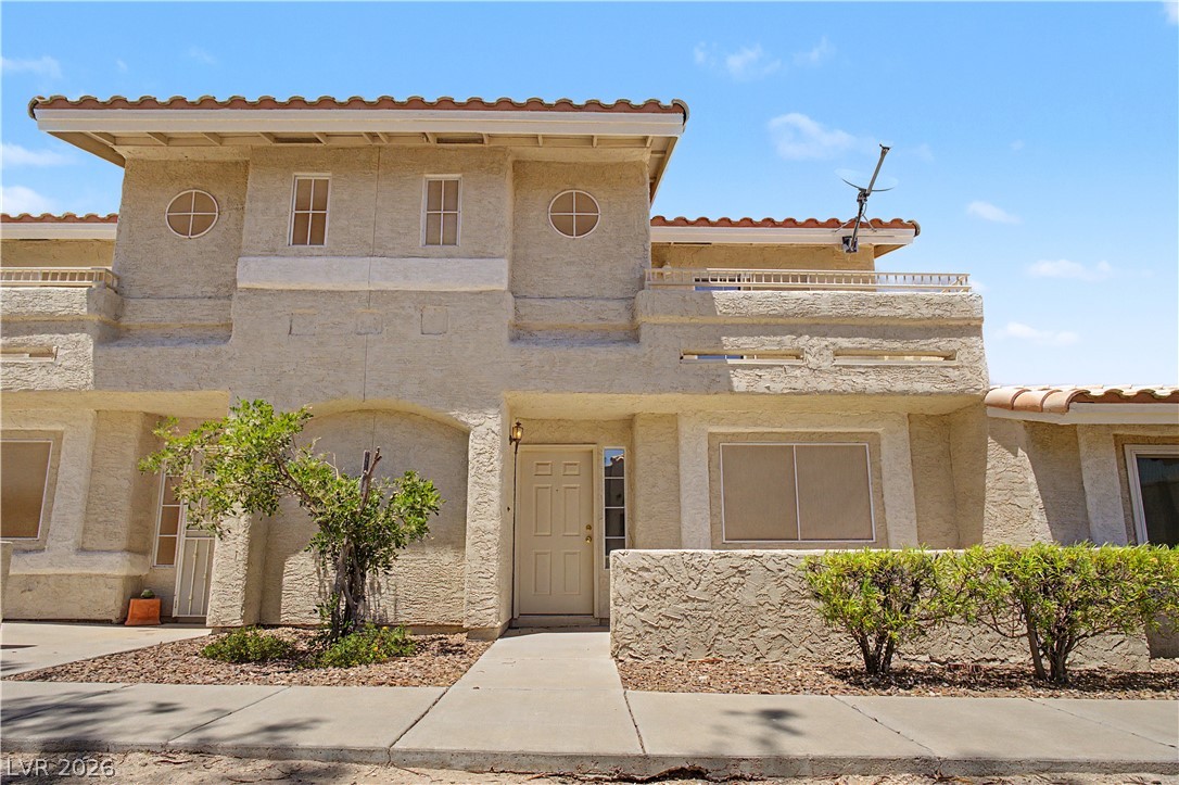 2243 Rugged Mesa Drive Laughlin, NV 89029 - Photo 1 of 32 A cream-colored stucco exterior with a tiled roof, inviting you home.