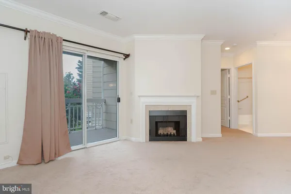 a view of an empty room with a fireplace