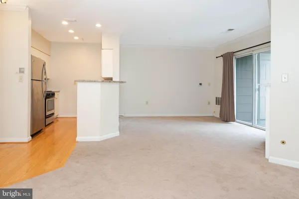 a view of a kitchen with a refrigerator and a sink