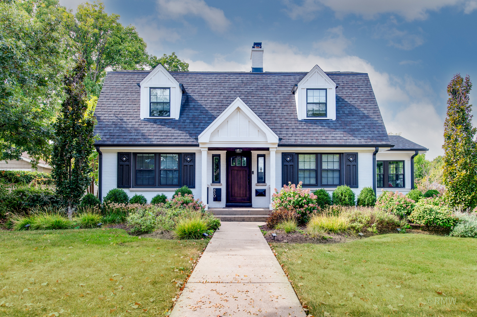 a front view of a house with garden