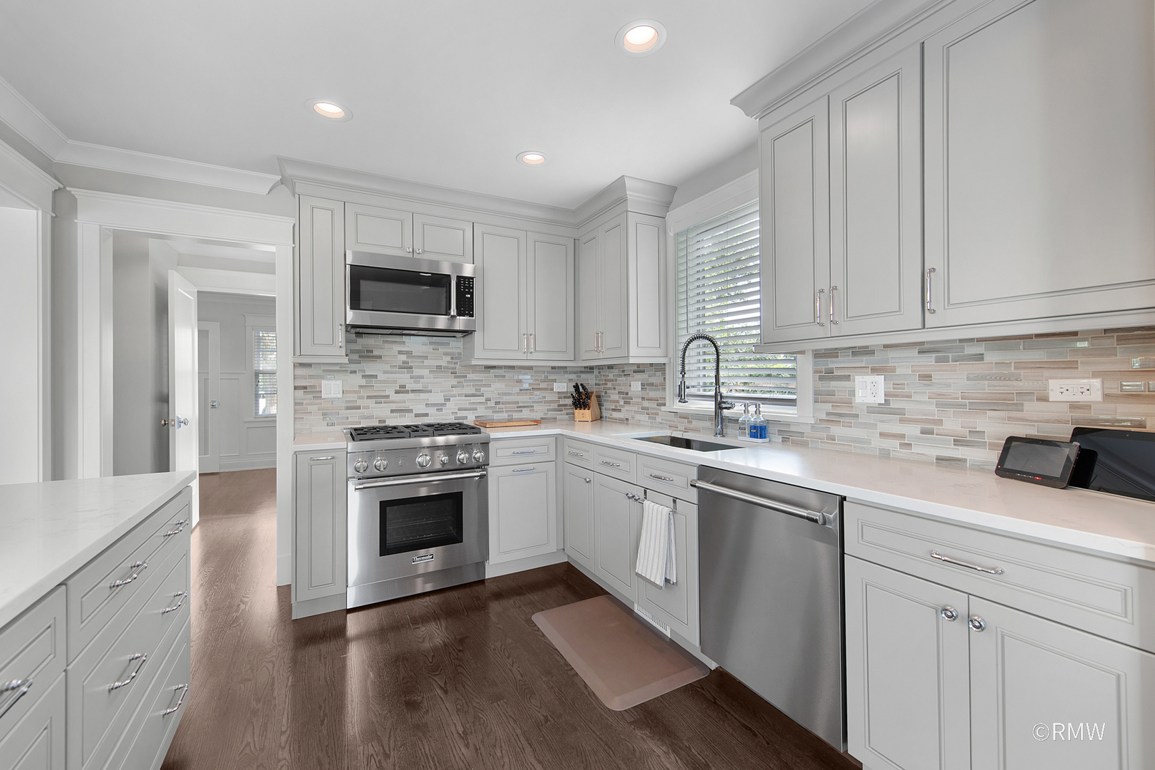 430 North Maple Street Itasca, IL 60143 - Photo 14 of 43 a kitchen with granite countertop white cabinets and stainless steel appliances