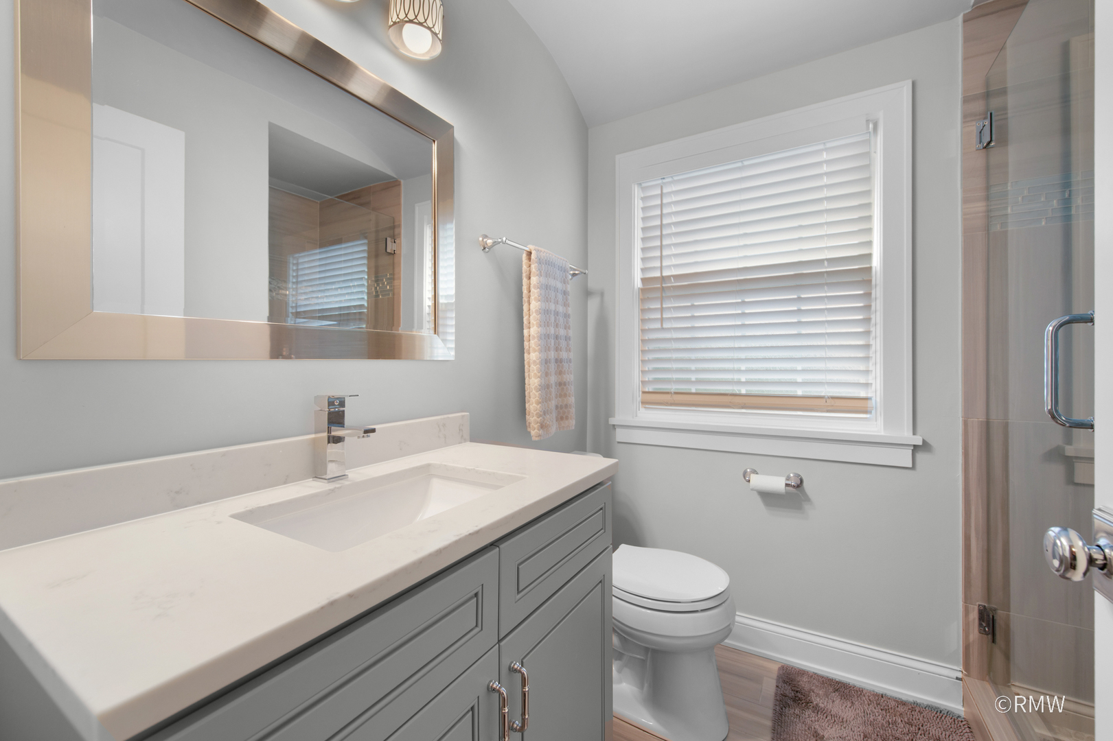 430 North Maple Street Itasca, IL 60143 - Photo 26 of 43 a bathroom with a sink a toilet and mirror