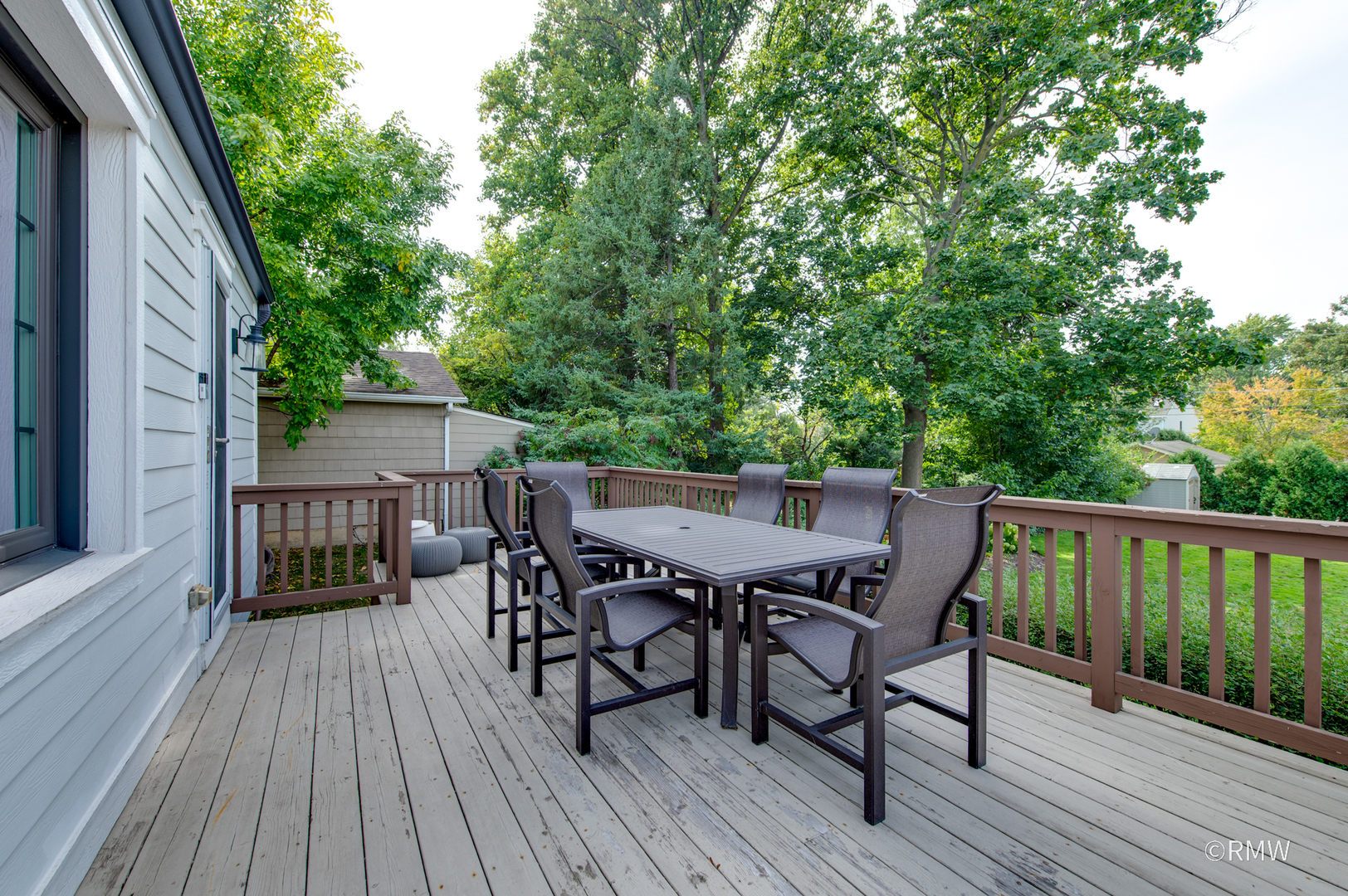 430 North Maple Street Itasca, IL 60143 - Photo 32 of 43 a view of a roof deck with table and chairs and wooden floor