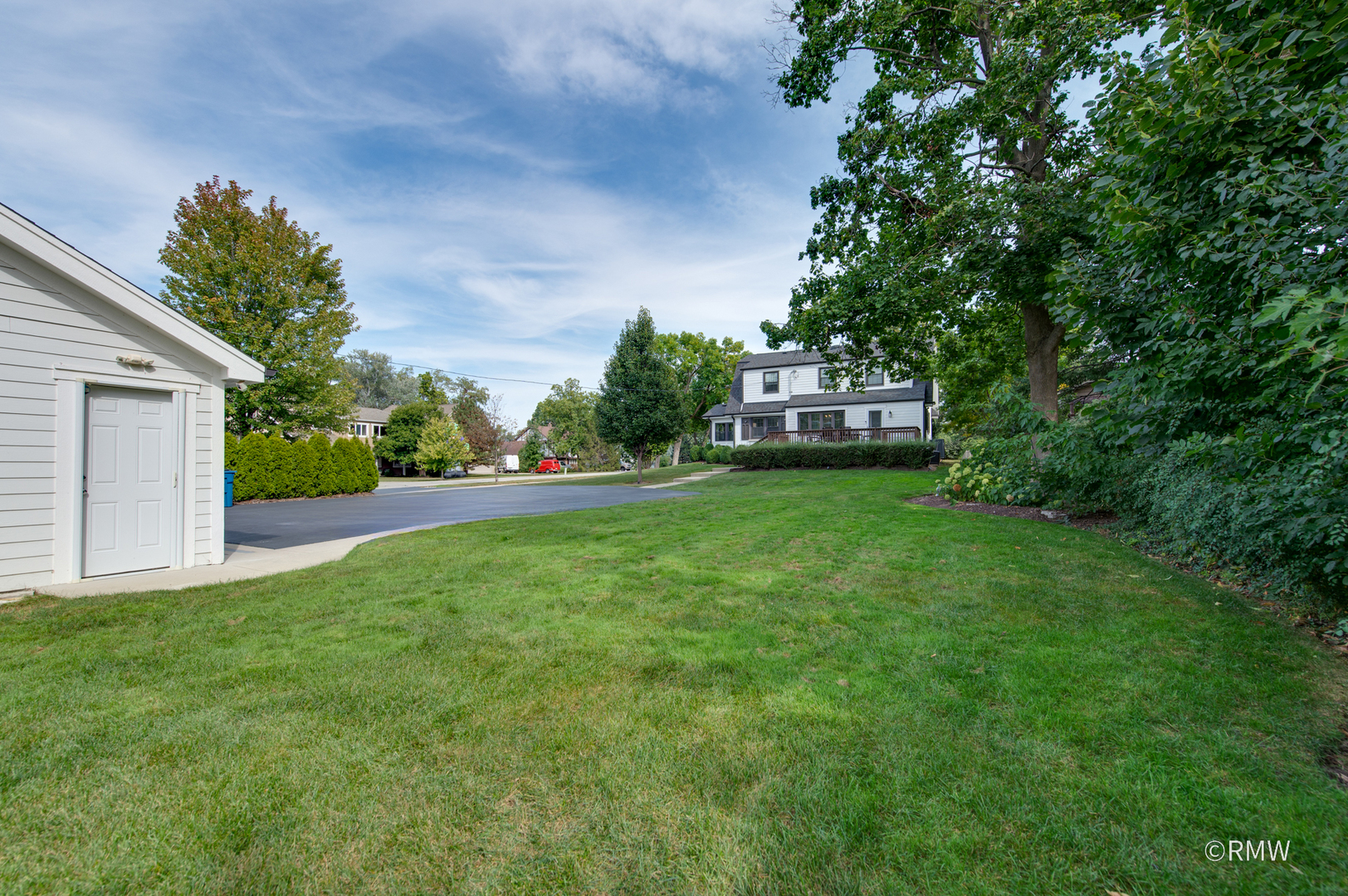 430 North Maple Street Itasca, IL 60143 - Photo 40 of 43 a view of a house with a big yard potted plants and large trees