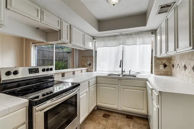 a kitchen with stainless steel appliances granite countertop a sink and cabinets