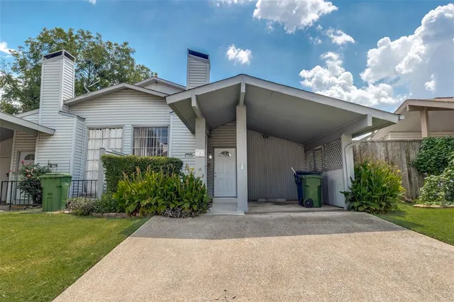 a front view of a house with a yard and a garage