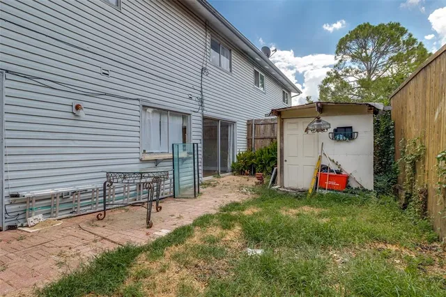 a backyard of a house with table and chairs
