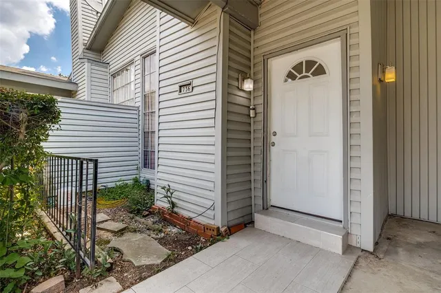 a view of front door and potted plants