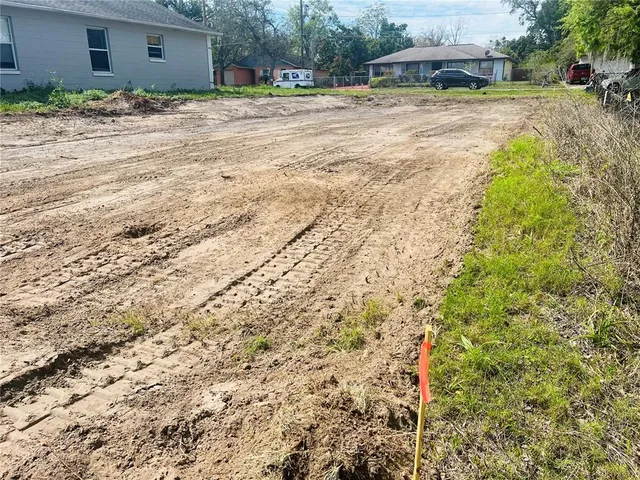 a view of a house with a yard and garage