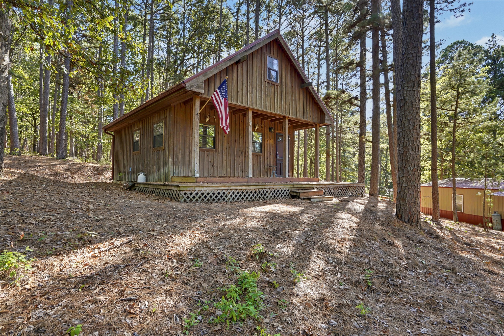 46420 South 590 Road Jay, OK 74346 - Photo 2 of 63 Wood-sided cabin featuring a covered porch, an A-frame roof, and multiple windows
