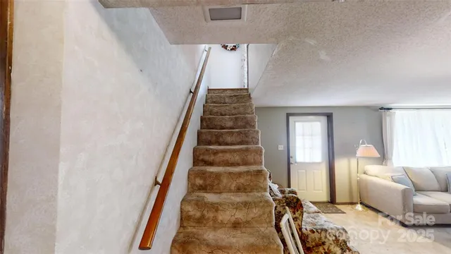 a living room with furniture and a mirror