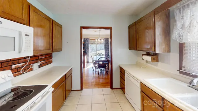 a kitchen with a sink stove top oven and cabinets