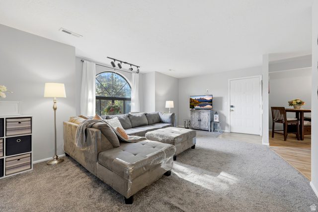 1175 Canyon Road, Unit 86 Ogden, UT 84404 - Photo 6 of 29 Spacious living area featuring carpet flooring and light gray walls
