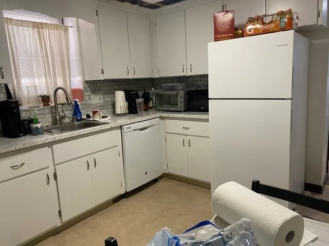 a kitchen with a sink appliances and cabinets