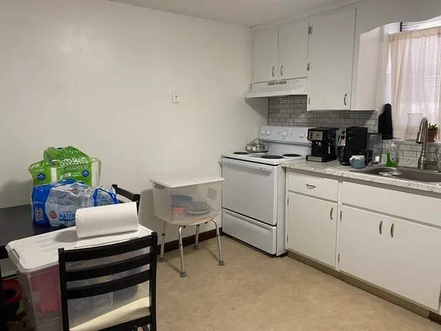 a kitchen with cabinets and window