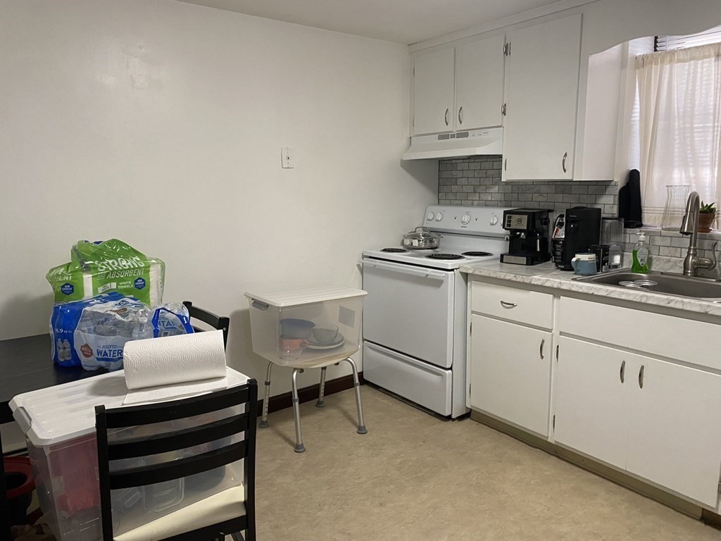 21 Irving Street, Unit 1 Revere, MA 02151 - Photo 4 of 8 a kitchen with cabinets and window