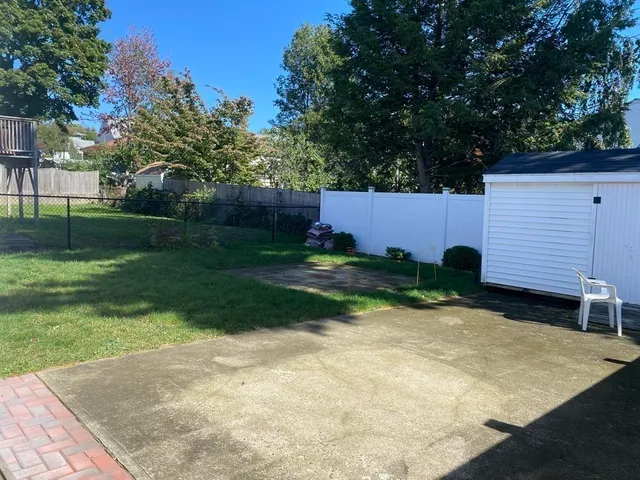 a view of backyard with a garden and trees