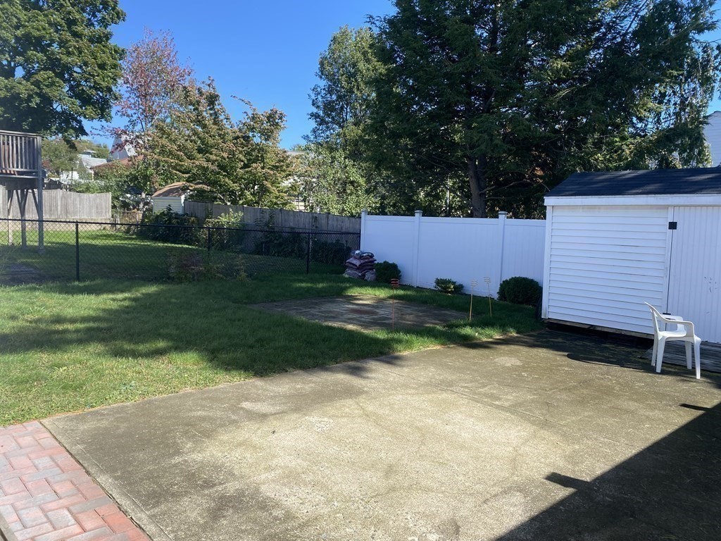21 Irving Street, Unit 1 Revere, MA 02151 - Photo 8 of 8 a view of backyard with a garden and trees