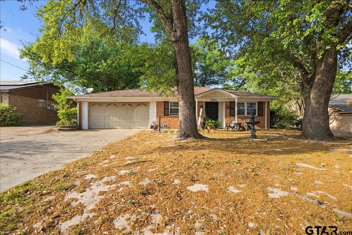 3211 Shady Trail Drive Tyler, TX 75702 - Photo 1 of 30 a front view of a house with a yard