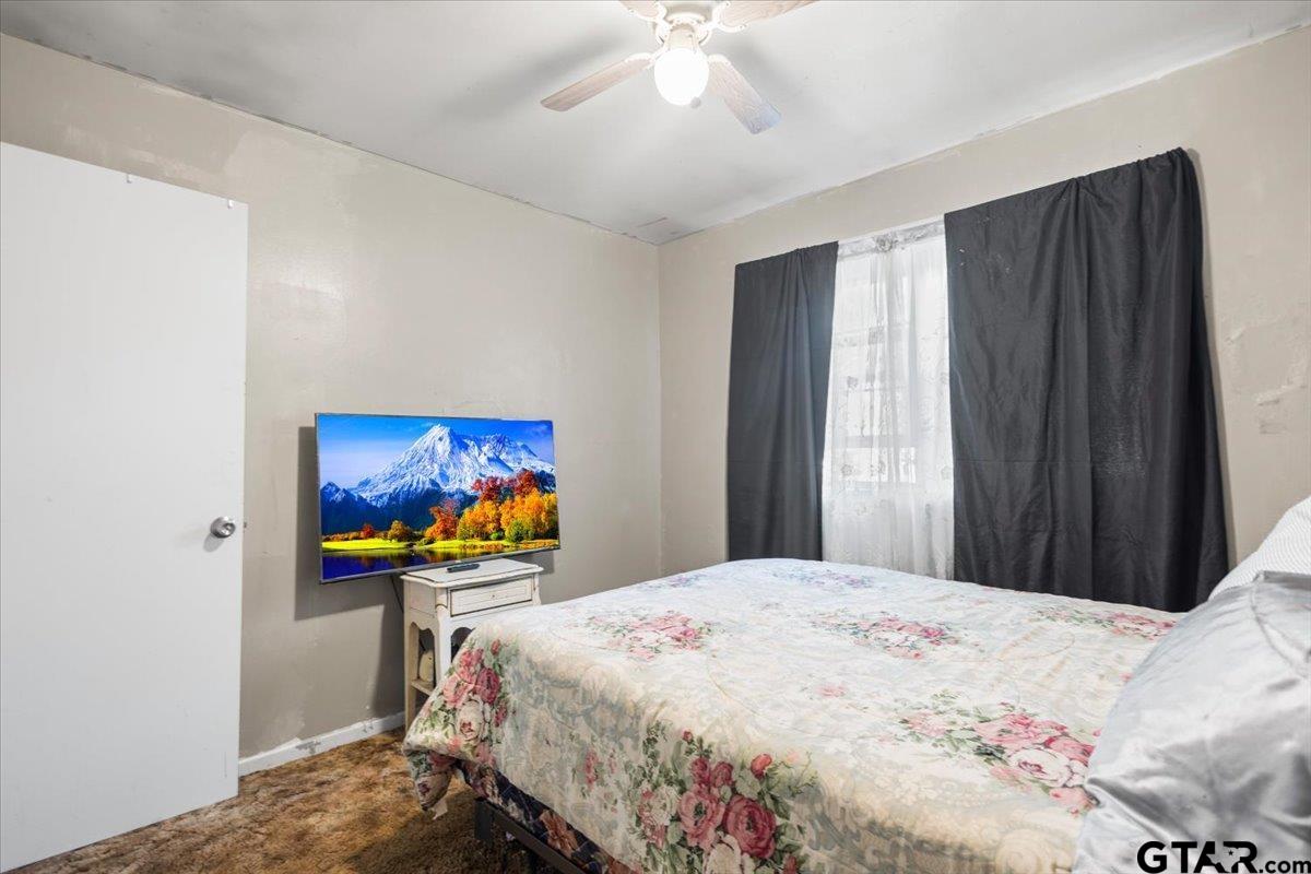 3211 Shady Trail Drive Tyler, TX 75702 - Photo 19 of 30 a bedroom with a bed and a painting on the wall