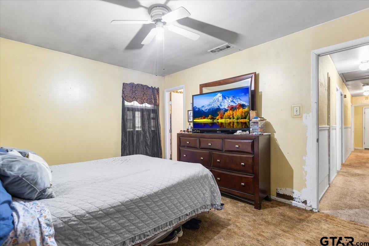 3211 Shady Trail Drive Tyler, TX 75702 - Photo 23 of 30 a bedroom with a bed and a flat screen tv