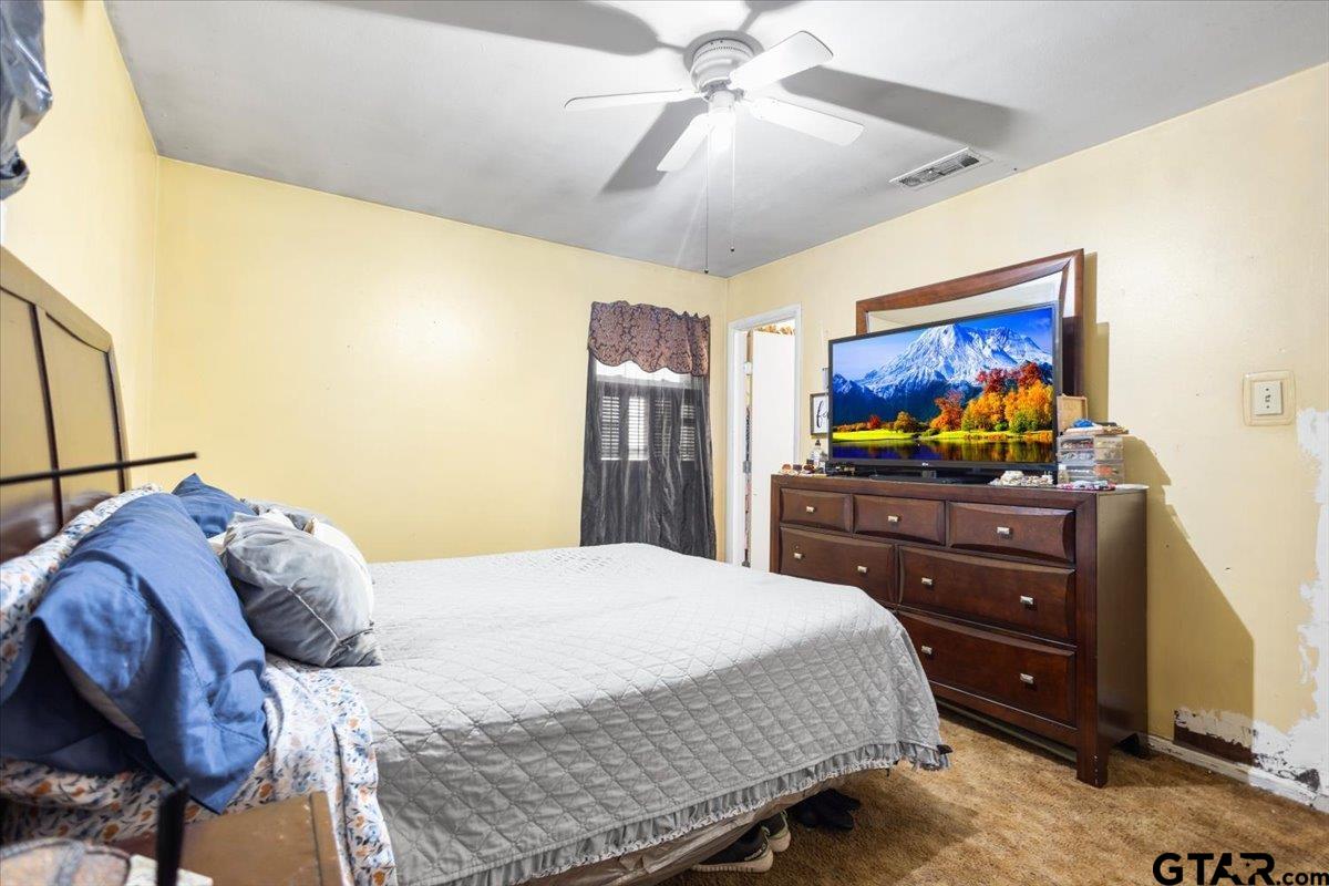 3211 Shady Trail Drive Tyler, TX 75702 - Photo 24 of 30 a bedroom with a bed and ceiling fan