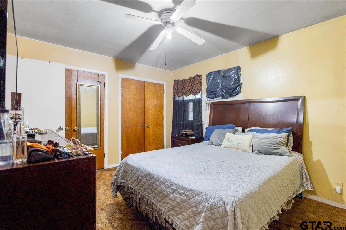 3211 Shady Trail Drive Tyler, TX 75702 - Photo 25 of 30 a bedroom with a bed and wooden floor