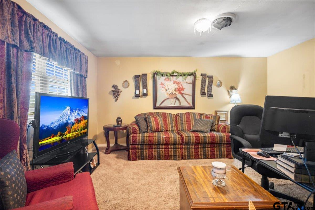3211 Shady Trail Drive Tyler, TX 75702 - Photo 5 of 30 a bedroom with furniture and a flat screen tv