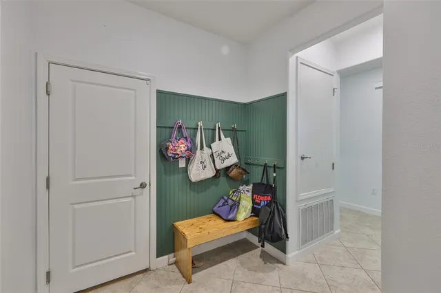 a view of game room with baby crib