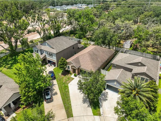 an aerial view of a house with swimming pool and garden