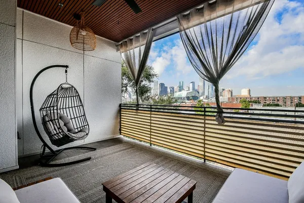a view of a livingroom with wooden floor and furniture