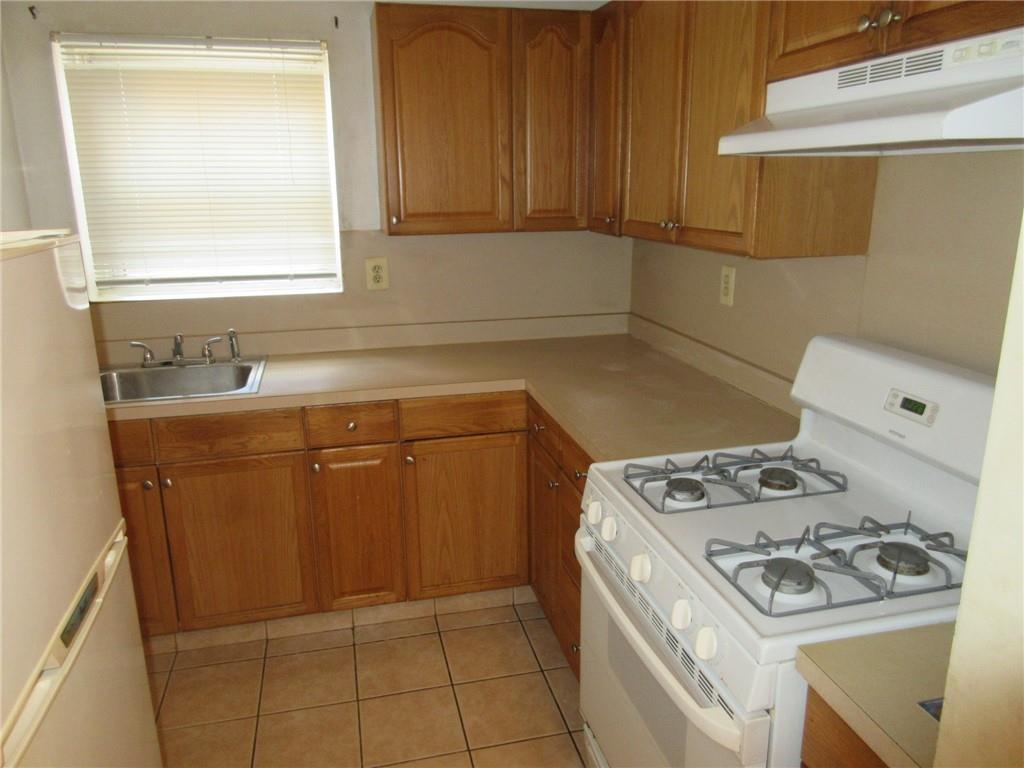 320 South Broadway, Unit R4 Tarrytown, NY 10591 - Photo 1 of 1 a kitchen with a sink stove and cabinets