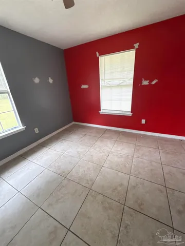 a view of a livingroom with an empty space and a window