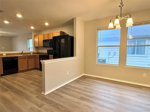 a kitchen with stainless steel appliances granite countertop a sink a stove and a refrigerator