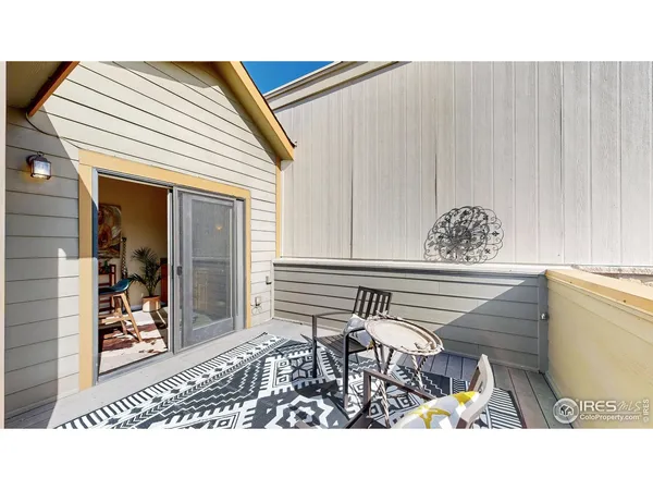 a outdoor space with a table and chairs