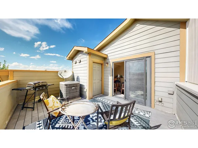a balcony with chairs and view of city view