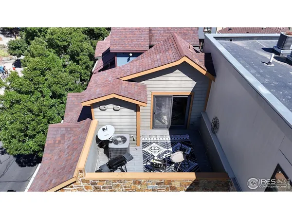 an aerial view of multiple houses with a yard