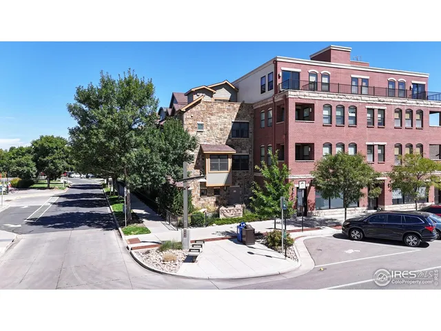 a living room with dining table and a chandelier