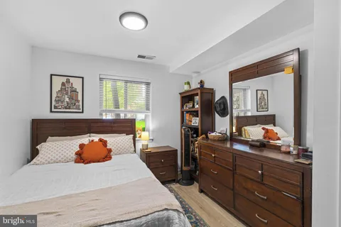 a bedroom with a bed and a dresser