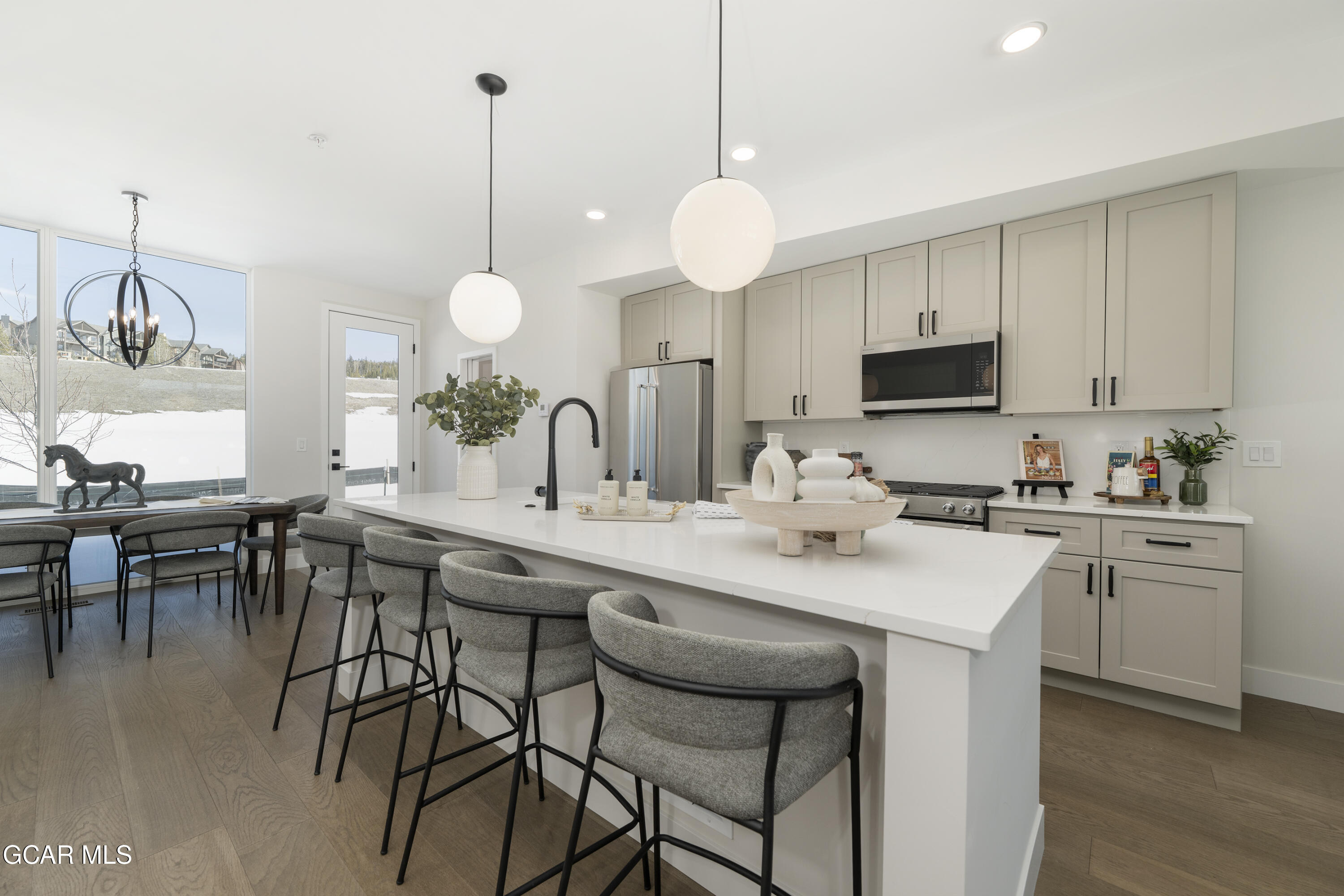 a kitchen with center island table and chairs in it